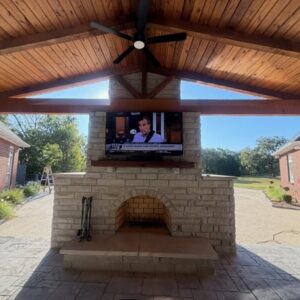 Landscape design and installation with a patio and outdoor fireplace and patio cover in Tulsa, Oklahoma.