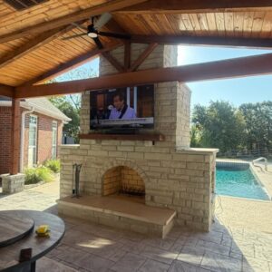 Patio installation and outdoor living installation in Tulsa, Oklahoma.  Includes an outdoor fireplace and pergola and pavilion installation.